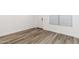 Bedroom with neutral walls, wood-look flooring, and bright window at 17704 W Mission Ln, Waddell, AZ 85355