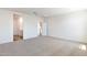 Bright bedroom with plush carpeting, recessed lighting, and views to bathroom and kitchen at 17704 W Mission Ln, Waddell, AZ 85355