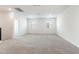 Large bonus room with neutral carpet, and natural light from the two windows at 17704 W Mission Ln, Waddell, AZ 85355