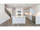 Contemporary kitchen with stainless steel appliances, white cabinetry, and an island with quartz countertops at 17704 W Mission Ln, Waddell, AZ 85355