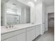 Bright bathroom featuring double vanity, large mirror, and a walk-in closet at 17744 W Hatcher Rd, Waddell, AZ 85355