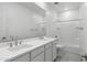 Bathroom featuring double sinks with modern fixtures and a shower-tub combo at 17744 W Hatcher Rd, Waddell, AZ 85355
