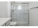 Bathroom with a glass shower enclosure and white fixtures at 17744 W Hatcher Rd, Waddell, AZ 85355
