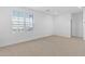 Bright bedroom with large windows, plush carpet, and neutral decor at 17744 W Hatcher Rd, Waddell, AZ 85355