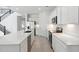 Modern kitchen boasts stainless steel appliances, white cabinets, a spacious island, and recessed lighting throughout at 17744 W Hatcher Rd, Waddell, AZ 85355