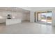 Open-concept kitchen boasts stainless appliances, sleek countertops, and easy access to the backyard through sliding doors at 17744 W Hatcher Rd, Waddell, AZ 85355