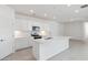 Modern kitchen with white cabinets, stainless steel appliances, and large center island at 17744 W Hatcher Rd, Waddell, AZ 85355