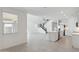 Open-concept living room featuring tile floors, a staircase, and kitchen view at 17744 W Hatcher Rd, Waddell, AZ 85355