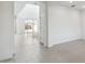 Bright, open-concept living space with large windows and sliding glass doors with neutral tile throughout at 17744 W Hatcher Rd, Waddell, AZ 85355