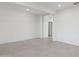 Inviting living space featuring neutral tile floors, bright walls, and ample natural light from nearby windows at 17744 W Hatcher Rd, Waddell, AZ 85355