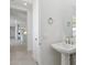 Stylish powder room features a pedestal sink and modern fixtures at 17744 W Hatcher Rd, Waddell, AZ 85355