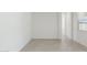 Bright, tiled room with plenty of natural light and neutral decor at 17744 W Hatcher Rd, Waddell, AZ 85355