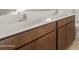 Bathroom vanity with double sinks and dark wood cabinets at 17788 W Getty Dr, Goodyear, AZ 85338
