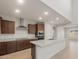 Open kitchen with stainless steel appliances, granite countertops, and rich dark cabinetry at 17788 W Getty Dr, Goodyear, AZ 85338