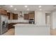 Modern kitchen with stainless steel appliances, granite countertops, and rich dark cabinetry at 17788 W Getty Dr, Goodyear, AZ 85338