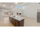 Bright, open-concept kitchen features a large island, tile flooring, and ample space at 17788 W Getty Dr, Goodyear, AZ 85338
