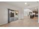 Open living space with tile floors, sliding doors to the patio, and a view of the kitchen at 17788 W Getty Dr, Goodyear, AZ 85338