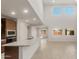 Bright living room featuring an open floor plan, recessed lights, and sleek tile floors at 17788 W Getty Dr, Goodyear, AZ 85338