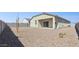 Spacious backyard with gravel landscaping and a covered patio, perfect for outdoor entertaining at 18377 W Gray Fox Trl, Wittmann, AZ 85361