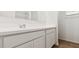 Bathroom featuring white vanity with quartz counters, under-mount sink, and chrome faucet at 18377 W Gray Fox Trl, Wittmann, AZ 85361