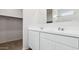 Bright bathroom boasts double sinks, white cabinets and a large mirror perfect for getting ready at 18377 W Gray Fox Trl, Wittmann, AZ 85361
