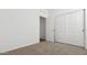 Bedroom with carpet, closet with sliding doors, and attached bath at 18377 W Gray Fox Trl, Wittmann, AZ 85361