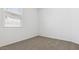 Neutral bedroom with cozy carpeting and bright window at 18377 W Gray Fox Trl, Wittmann, AZ 85361