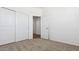 Bedroom with carpet, closet with sliding doors, and attached bath at 18377 W Gray Fox Trl, Wittmann, AZ 85361