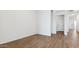 Bright bedroom featuring wood-look tile flooring and neutral paint throughout at 18377 W Gray Fox Trl, Wittmann, AZ 85361