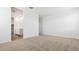 Spacious bedroom featuring carpet flooring, white walls, and a walk-in closet for ample storage at 18377 W Gray Fox Trl, Wittmann, AZ 85361