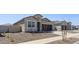 Charming single-story home with desert landscaping and a sidewalk, featuring a well-kept lawn at 18377 W Gray Fox Trl, Wittmann, AZ 85361