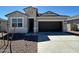 Charming single-Gathering home featuring a two-car garage, desert landscaping, and a welcoming entrance at 18377 W Gray Fox Trl, Wittmann, AZ 85361