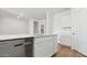 Bright kitchen with stainless steel dishwasher, modern cabinets, and island with stone countertop at 18377 W Gray Fox Trl, Wittmann, AZ 85361