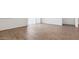 Bright living room featuring wood-look tile flooring and base molding at 18377 W Gray Fox Trl, Wittmann, AZ 85361