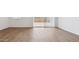 Bright living room showcasing wood-look tile flooring and sliding glass doors at 18377 W Gray Fox Trl, Wittmann, AZ 85361