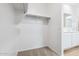 Spacious walk-in closet featuring carpet flooring and built-in shelving for ample storage and organization at 18377 W Gray Fox Trl, Wittmann, AZ 85361