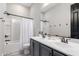 Modern bathroom featuring dual sinks, tub with shower, and neutral color palette at 1980 E Horseshoe Dr, Chandler, AZ 85249