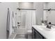 Bright bathroom featuring a shower-tub combination, white cabinets, and modern fixtures at 1980 E Horseshoe Dr, Chandler, AZ 85249
