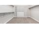 Spacious walk-in closet featuring custom shelving, drawers, and carpeted flooring at 1980 E Horseshoe Dr, Chandler, AZ 85249