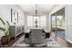 Elegant dining room with a modern chandelier, long table with bench seating, and sliding doors to the backyard at 1980 E Horseshoe Dr, Chandler, AZ 85249