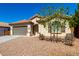 A single-story home with a gray two-car garage and desert landscaping under a blue sky at 1980 E Horseshoe Dr, Chandler, AZ 85249