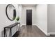 Welcoming foyer features modern design with a black console table and accent mirror at 1980 E Horseshoe Dr, Chandler, AZ 85249