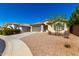 Attractive single-Gathering home featuring desert landscaping, a two-car garage, and a well-manicured front yard under a blue sky at 1980 E Horseshoe Dr, Chandler, AZ 85249