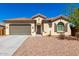 Charming single-story home with a well-maintained front yard, desert landscaping, a two-car garage, and a tile roof at 1980 E Horseshoe Dr, Chandler, AZ 85249
