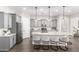 Modern kitchen featuring gray cabinets, granite countertops, stainless steel appliances, and an expansive island with bar seating at 1980 E Horseshoe Dr, Chandler, AZ 85249