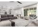 Spacious living room with a comfortable sectional sofa, modern decor, and an open layout connecting to the kitchen at 1980 E Horseshoe Dr, Chandler, AZ 85249