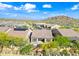 Aerial view of a community showcasing mountain views, desert landscaping, and nearby highway at 2040 N Dome Rock --, Mesa, AZ 85207