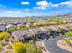 Aerial view of homes in a desert community showcasing tile roofs and mature landscaping at 2040 N Dome Rock --, Mesa, AZ 85207