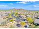 An aerial view of a community with well-maintained streets and desert landscaping; surrounded by scenic mountains at 2040 N Dome Rock --, Mesa, AZ 85207