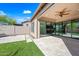 Beautifully landscaped backyard featuring travertine patio, artificial turf, and seamless access to the interior through sliding glass doors at 2040 N Dome Rock --, Mesa, AZ 85207
